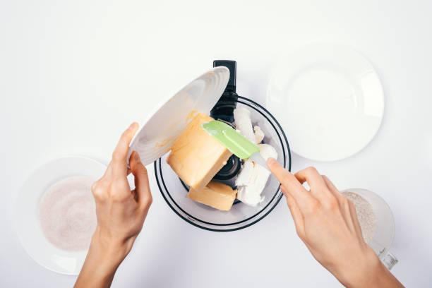 istock Top view of woman's hands add ingredients for dough 1125631764
