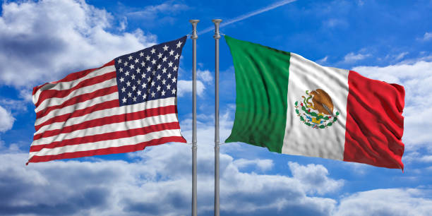 istock USA and Mexican waving opposite flags on blue sky background. 3d illustration 1125634541