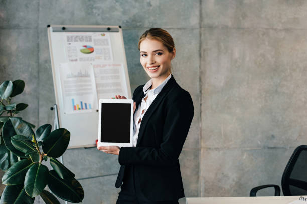 istock Smiling businesswoman holding digital tablet with black screen 1125635291
