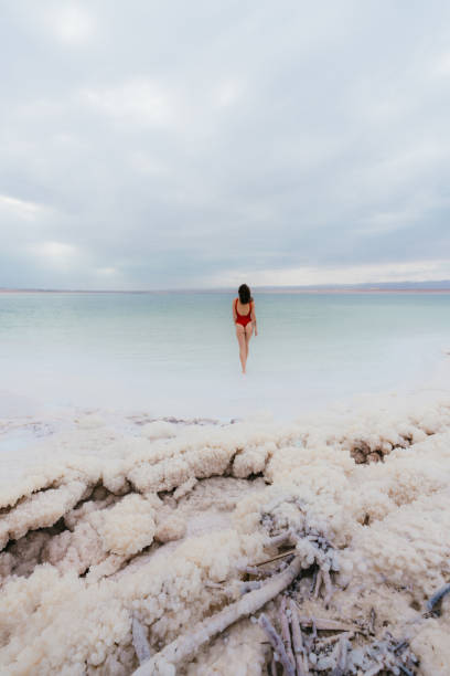 istock Woman walking into Dead Sea 1125635661