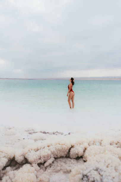 istock Woman walking into Dead Sea 1125635666