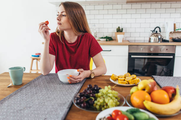 ホーム食べる果物や野菜トップ ビューで女性。 - model home house home interior plate ストックフォトと画像