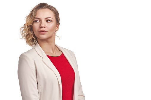Stylish positive woman wearing jacket looking to side, over white background