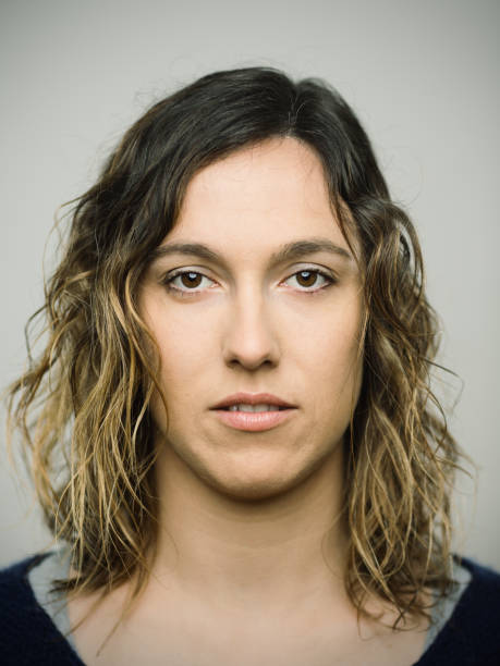 istock Real caucasian young woman with blank expression looking at camera 1125638891