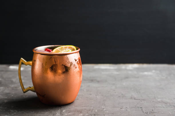 istock Sweet moscow mule with lime and raspberry in copper mug on the rustic background 1125640293