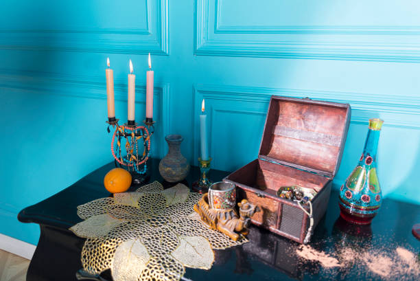 istock Chest, candles and a bottle on the stele. 1125641288