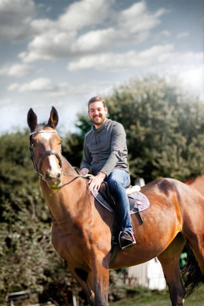 istock Smiling rider man on horse 1125643338