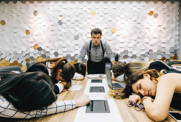 Business people sleeping in the conference room at the meeting Business man looking at tired colleagues sleeping exhausted from hard work in the conference room during a meeting. Emotional Stress, Working, Occupation concept. oversleeping stock pictures, royalty-free photos & images
