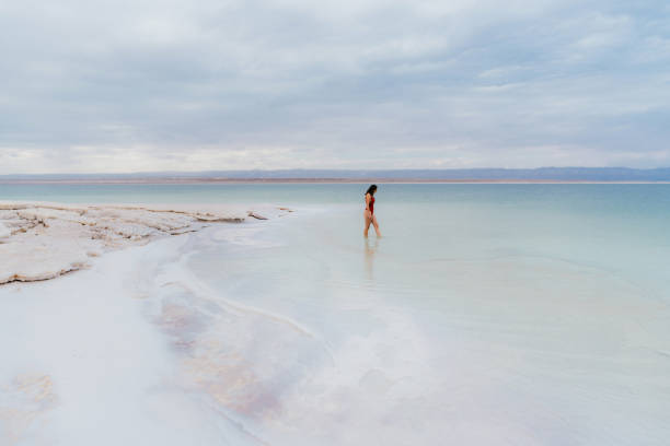 istock Woman walking into Dead Sea 1125644086
