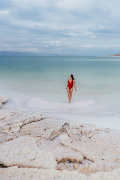 istock Woman walking into Dead Sea 1125644119