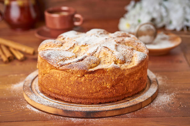 istock Apple french cake with apples, cinnamon on dark wooden kitchen table, side view 1125645228