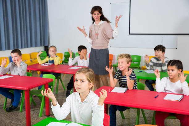 istock Schoolchildren with teacher performing physical exercises 1125646296