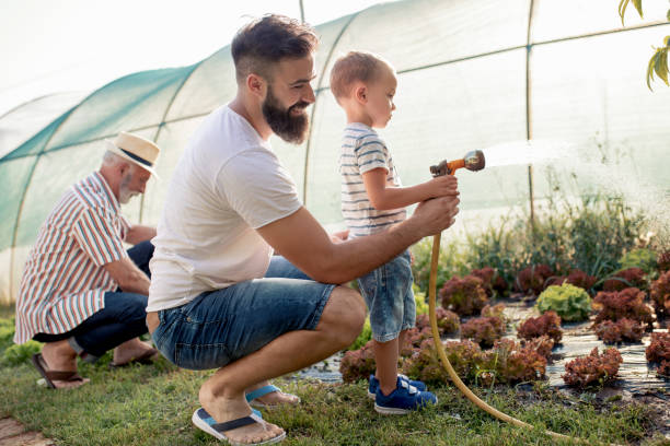 istock Young father with his son working in the garden 1125646998
