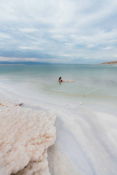 istock Woman floating on water  in Dead Sea 1125650446