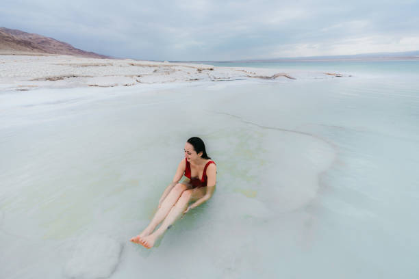 istock Woman floating on water  in Dead Sea 1125650449