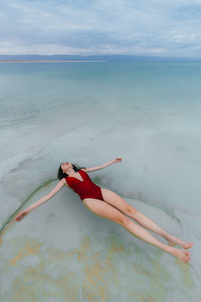 istock Woman floating on water  in Dead Sea 1125650530