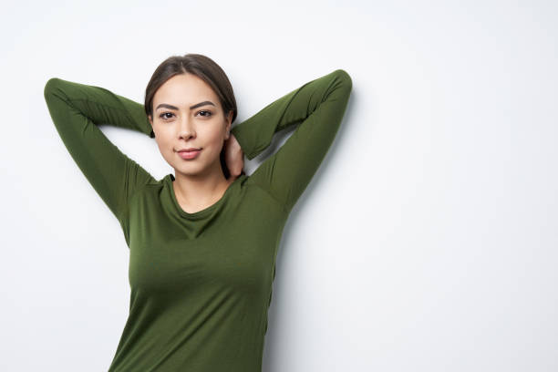 istock Young brunette woman posing with hands over head 1125652083