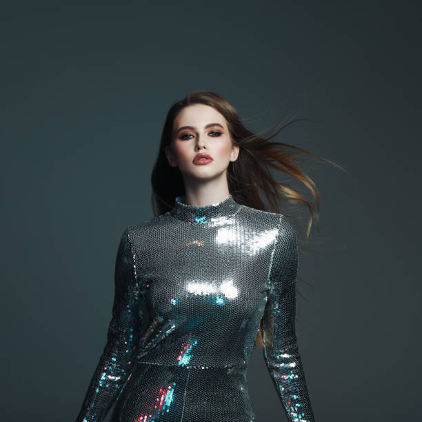 istock Beautiful young woman in sequin jumpsuit 1125652363