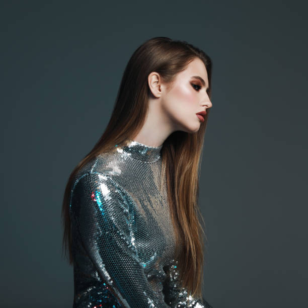istock Beautiful young woman in sequin top 1125652574