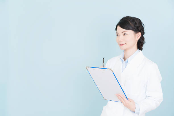 istock woman wearing white coat 1125653022