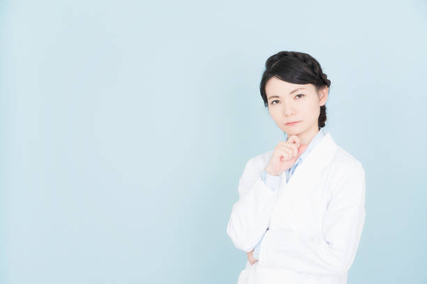 istock woman wearing white coat 1125653175
