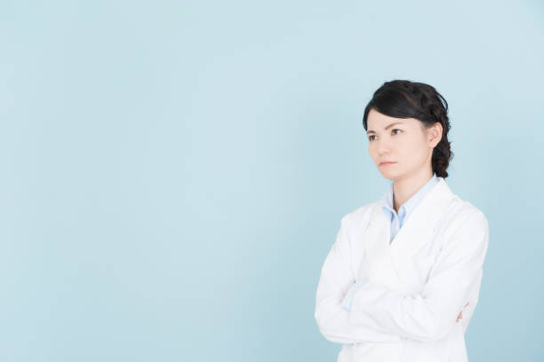 istock woman wearing white coat 1125653182
