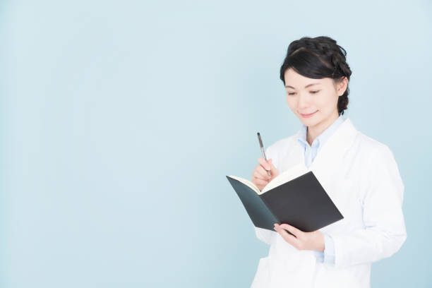 istock woman wearing white coat 1125653263