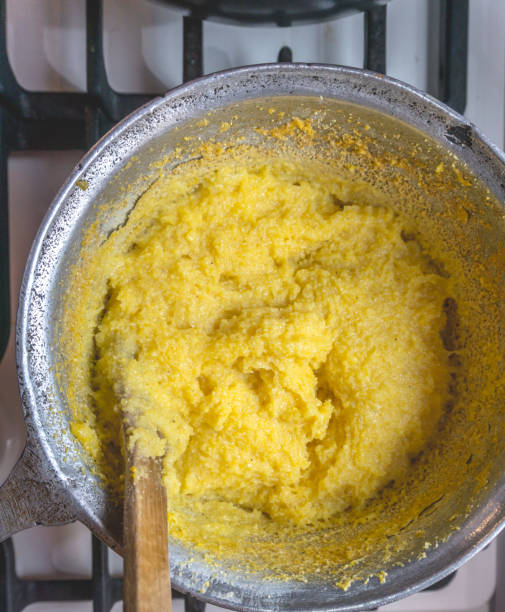 Polenta in cauldron - wooden spoon.