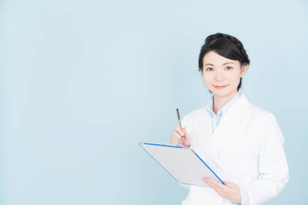 istock woman wearing white coat 1125653361