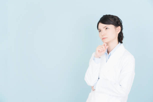 istock woman wearing white coat 1125653407