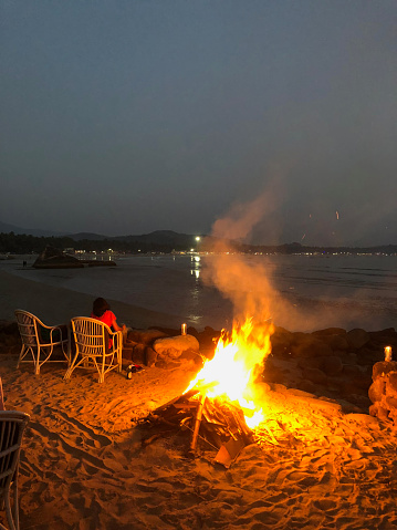 Tranquil evening bonfire on Palolem Beach, Goa, India.