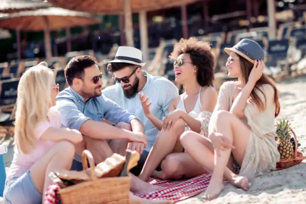 Summer,holidays, vacation, music, happy people concept -group of friends  having fun on the beach.