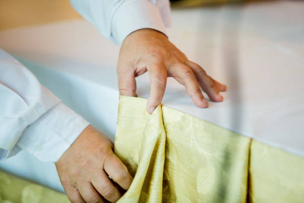 istock Hands of staff preparing the tablecloth with pin and decorations 1125656672