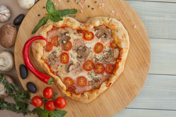 istock Pizza heart shaped on wood 1125657323