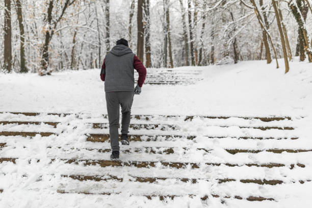 Senior man jogging in snow