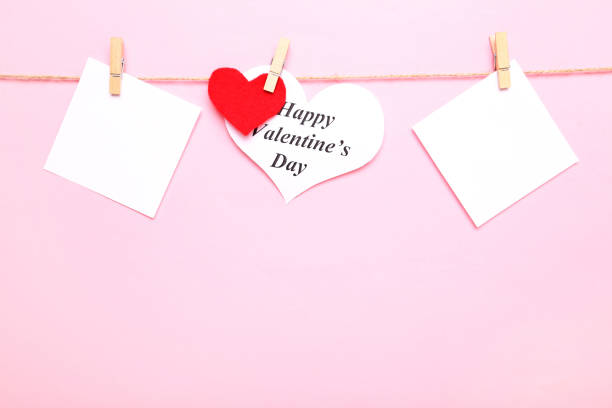 istock Paper with text Happy Valentine Day hanging on pink background 1125659669