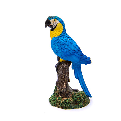 Beautiful decorative ceramic figurine of blue with yellow macaw parrot, isolate on white background