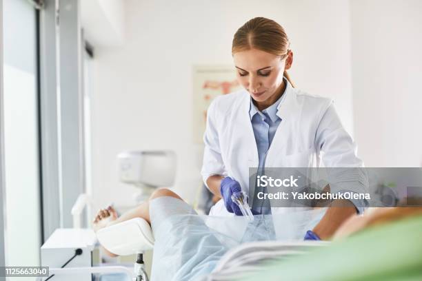 Young Doctor Doing Gynecological Examination Of Woman Stock Photo - Download Image Now