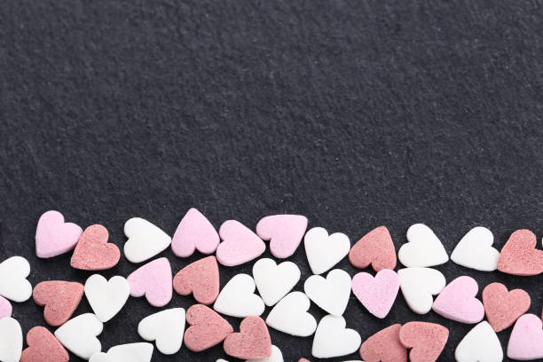 istock Heart shaped sprinkles on black background 1125663226