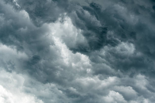 istock storm cloud background during raining. Dark Clouds. Huge black clouds on dark sky before a thunder-storm. 1125664109