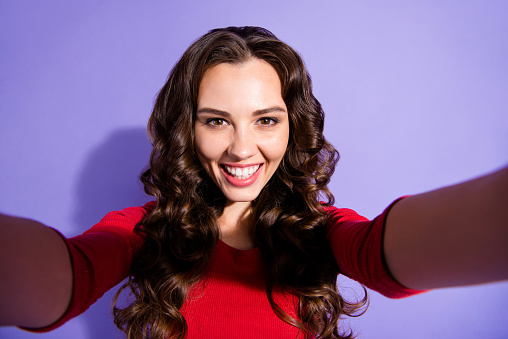 Close up photo of attractive pretty brunette she her girl speaking with relatives family by telephone camera glad to see love people person wearing red sweater on violet background