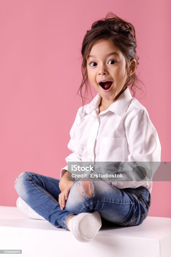 Cute Surprised Little Girl In White Shirt With Hairstyle Stock Photo -  Download Image Now - iStock