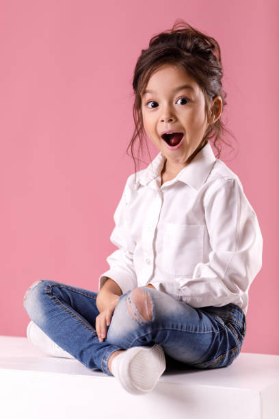 cute surprised little girl in white shirt with hairstyle - fashion model small one person happiness imagens e fotografias de stock