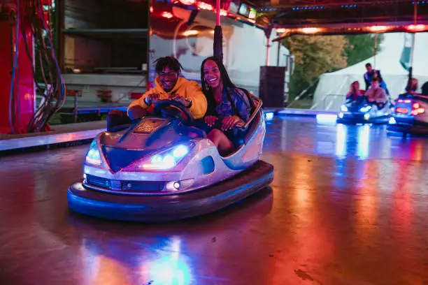 Photo of Young Couple on Bumper Cars