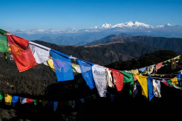 Tibetan prayer flag or Lung ta and Kangchenjunga high mountain range view from the Sandakphu , Darjeeling,  India