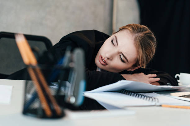 istock selective focus of beautiful businesswoman sleeping at work-table 1125670986