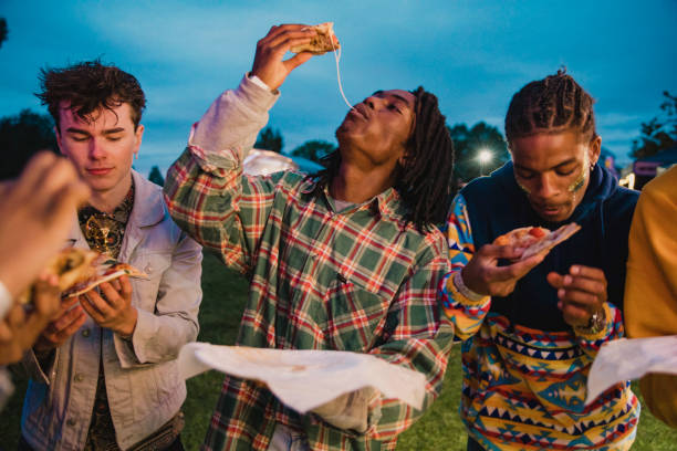 istock Young Men Eating Pizza at Festival 1125672802