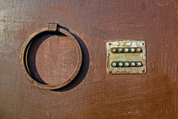 istock Old coded lock with round buttons on the iron door, close-up, old painted door, lock. Texture of paint on metal 1125674018