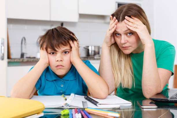 istock Displeased family doing homework 1125674186