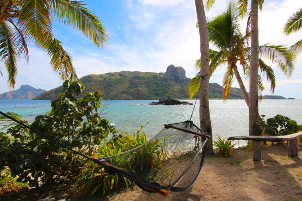 Relax in a hammock on the island of Kuata, in front of Wayasewa Island, Yasawa Islands, Fiji The Yasawa Group is an archipelago of about 20 volcanic islands in the Western Division of Fiji fiji photos stock pictures, royalty-free photos & images